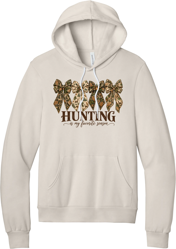 Hunting Is My Favorite Season hoodie in Heather Dust, featuring four camo coquette bows with antlers, acorns, and deer above Hunting Is My Favorite Season lettering