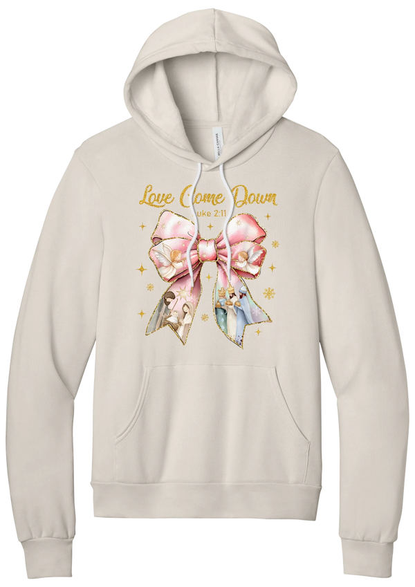 Love Came Down Nativity Bow hoodie in Heather Dust, featuring a blush satin bow with painted nativity scenes under gold Love Came Down script and Luke 2:11