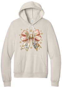 Nativity Bow hoodie in Heather Dust, featuring a blush satin bow with painted nativity scenes in its ribbons and gold snowflakes