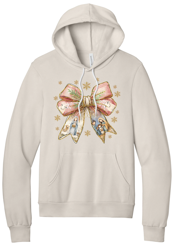 Nativity Bow hoodie in Heather Dust, featuring a blush satin bow with painted nativity scenes in its ribbons and gold snowflakes