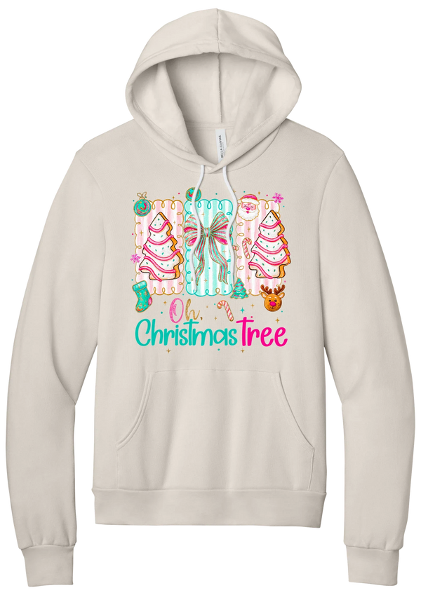 Oh Christmas Tree Cakes hoodie in Heather Dust, featuring frosted Christmas tree snack cakes on pink and mint panels over Oh Christmas Tree lettering