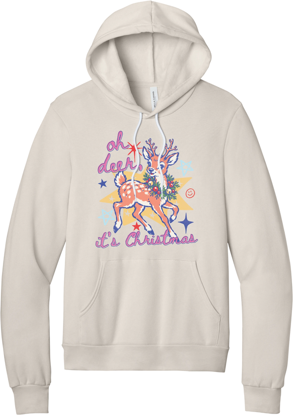 Oh Deer Retro hoodie in Heather Dust, featuring a retro spotted fawn with a holly wreath, pastel stars, and Oh Deer It's Christmas script