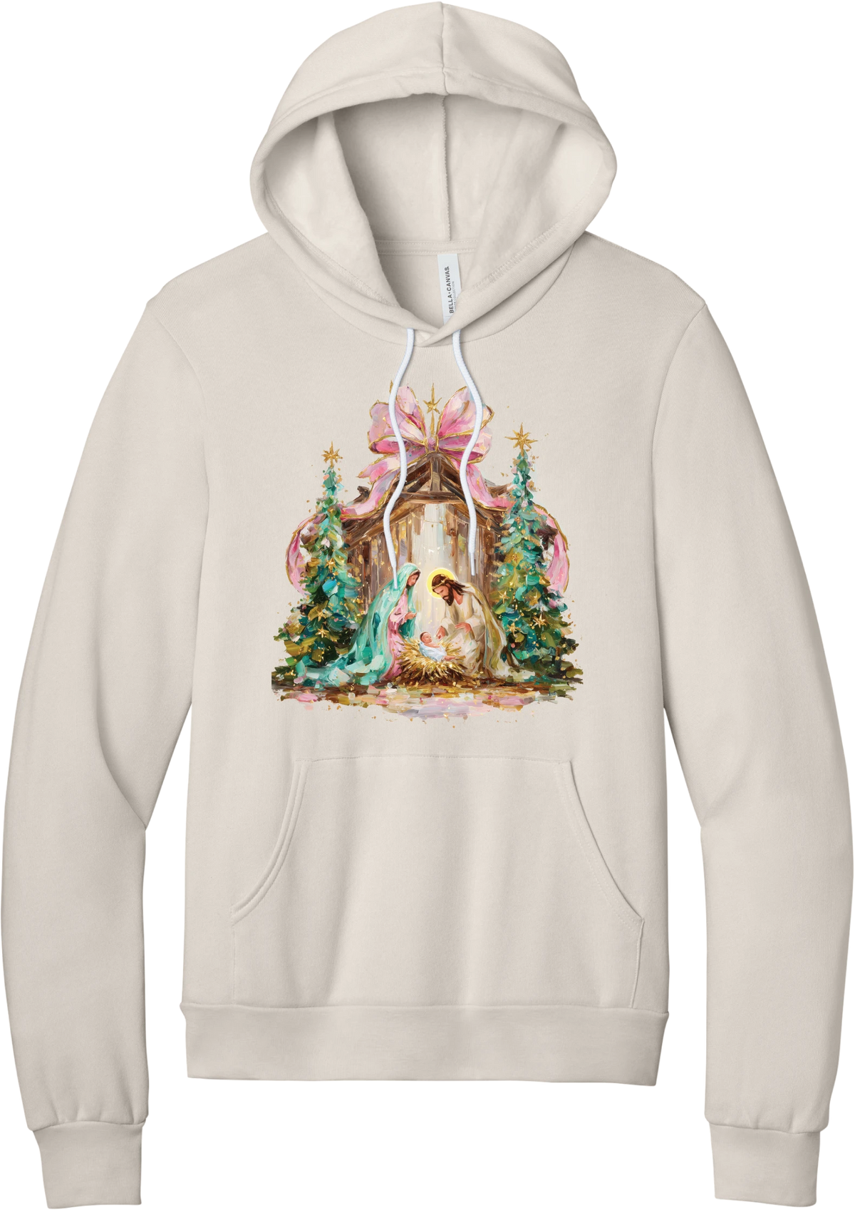 Painterly Nativity hoodie in Heather Dust, featuring a painterly nativity scene with Mary, Joseph, and baby Jesus in a wooden stable between teal Christmas trees and a pink bow