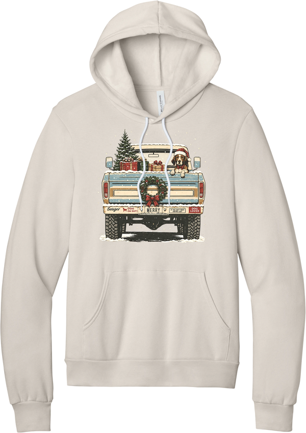 Christmas Pickup Truck with Dog hoodie in Heather Dust, featuring a vintage pickup truck with a Christmas tree, wrapped gifts, a tailgate wreath, and a dog in a Santa hat