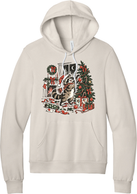 Raccoon Christmas hoodie in Heather Dust, featuring a vintage-style raccoon in a Santa hat and plaid scarf decorating a Christmas tree by the fireplace with ribbon and gifts scattered around