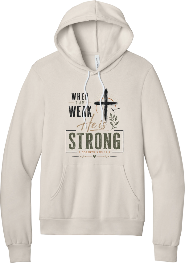 When I Am Weak hoodie in Heather Dust, featuring When I Am Weak He Is Strong lettering with a cross and 2 Corinthians 12:9