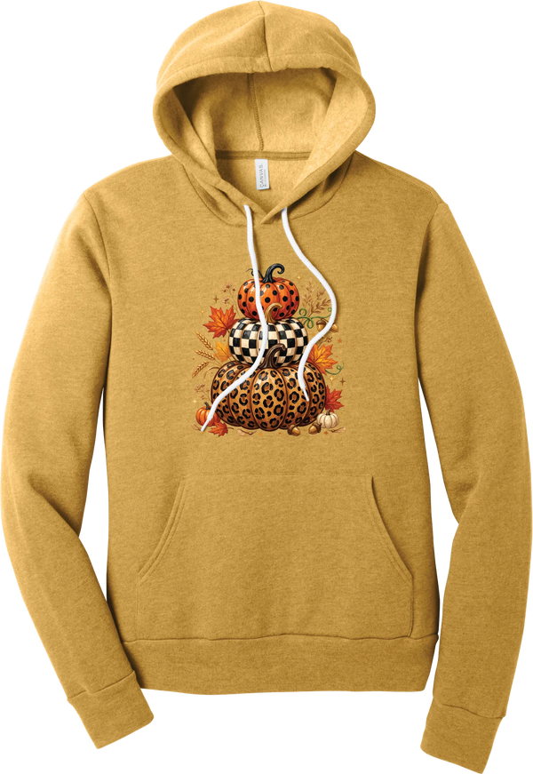 All Stacked Up hoodie in Heather Mustard, featuring three stacked pumpkins in polka dot, checkerboard, and leopard with autumn leaves