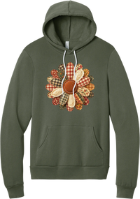 Patchwork Fabric Flower hoodie in Military Green, featuring an oversized fabric flower with plaid, gingham, calico, and cable knit petals around a stitched rust center