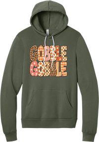 Gobble Gobble Patchwork hoodie in Military Green, featuring Gobble Gobble in bubble letters filled with leopard, gingham, checkerboard, stars, and pumpkin prints