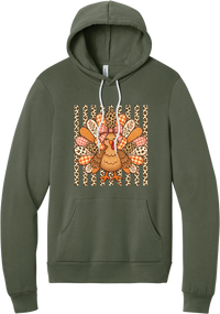 Preppy Turkey hoodie in Military Green, featuring a smiling turkey with gingham and leopard feathers and a pink bow on a leopard stripe background