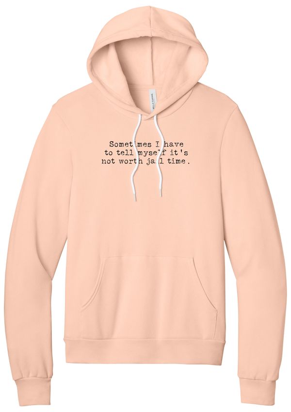 Not Worth Jail Time hoodie in Peach, featuring Sometimes I have to tell myself it's not worth jail time in distressed black typewriter letters