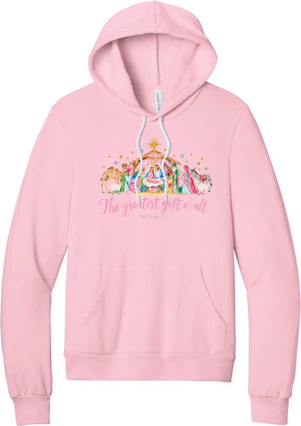 The Greatest Gift of All hoodie in Pink, featuring a pastel watercolor nativity scene under the star with The Greatest Gift of All script and Matthew 1:21