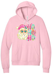 Ho Ho Ho Santa Portrait hoodie in Pink, featuring a pink-hatted Santa in teal heart sunglasses with stacked HO HO HO letters