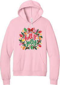 Holly Jolly Christmas Lights hoodie in Pink, featuring hand-lettered holly jolly script framed by vintage Christmas bulb lights, pine, holly berries, and a red bow