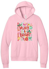 Merry and Bright Striped hoodie in Pink, featuring red MERRY and BRIGHT letters on pink and green stripes with ornaments and holly