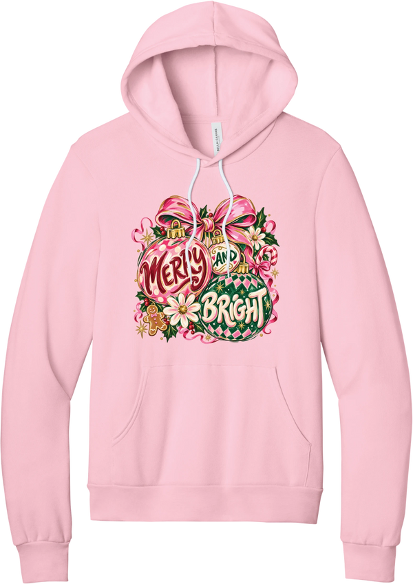 Merry and Bright Ornaments hoodie in Pink, featuring hand-painted pink and green ornaments reading Merry and Bright with a pink bow, holly, daisies, a candy cane, and a gingerbread man