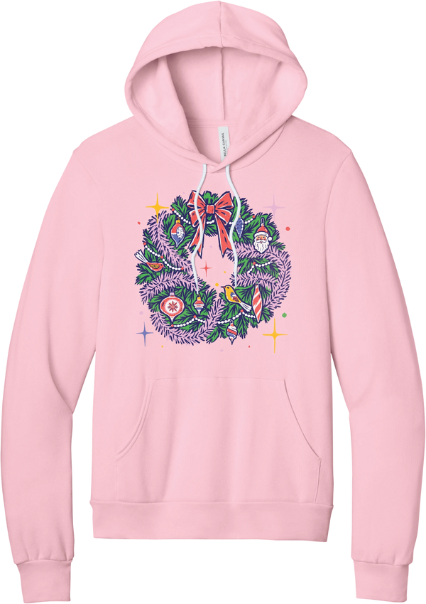Retro Wreath hoodie in Pink, featuring a retro tinsel Christmas wreath with vintage ornaments and a red bow