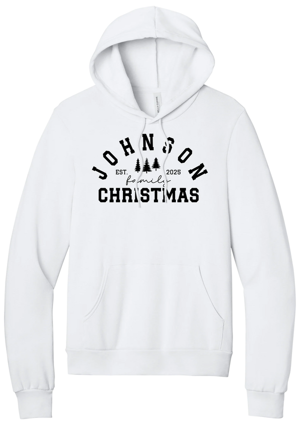 Personalized Family Christmas hoodie in White, featuring an arched family name over pine trees with EST. year and family Christmas lettering