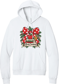 Merry Teachmas hoodie in White, featuring a red polka dot bow over a stack of books reading Teach, Inspire, Change with an apple, pencils, evergreen, and a Merry Teachmas banner