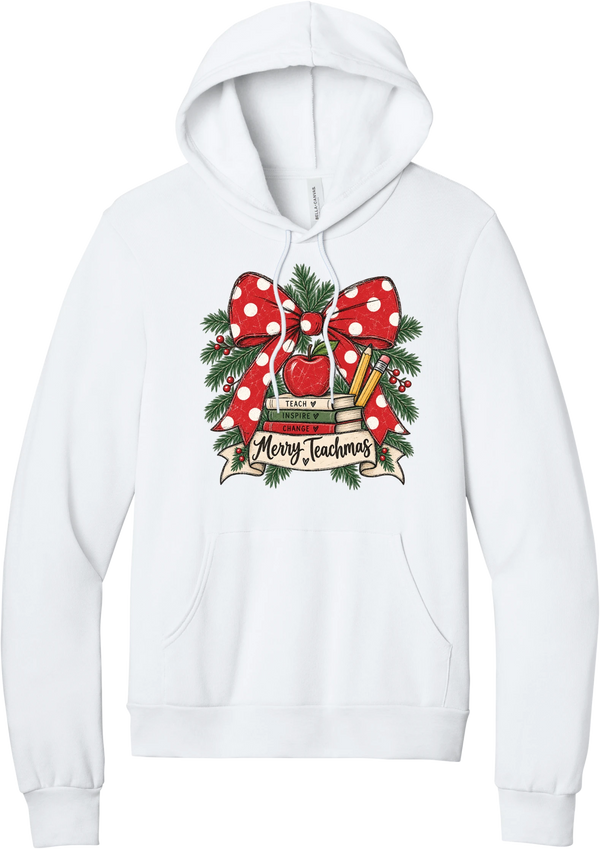 Merry Teachmas hoodie in White, featuring a red polka dot bow over a stack of books reading Teach, Inspire, Change with an apple, pencils, evergreen, and a Merry Teachmas banner