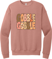 Gobble Gobble Patchwork crewneck sweatshirt in Mauve, featuring Gobble Gobble in bubble letters filled with leopard, gingham, checkerboard, stars, and pumpkin prints