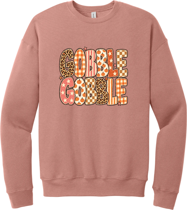 Gobble Gobble Patchwork crewneck sweatshirt in Mauve, featuring Gobble Gobble in bubble letters filled with leopard, gingham, checkerboard, stars, and pumpkin prints