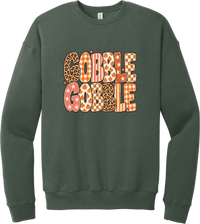 Gobble Gobble Patchwork crewneck sweatshirt in Military Green, featuring Gobble Gobble in bubble letters filled with leopard, gingham, checkerboard, stars, and pumpkin prints