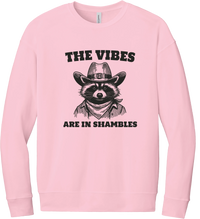 The Vibes Are in Shambles crewneck sweatshirt in Pink, featuring a cowboy raccoon in a bandana with The vibes are in shambles
