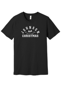 Personalized Family Christmas tee in Black, featuring a personalized family last name arched over three pine trees with EST. and the year