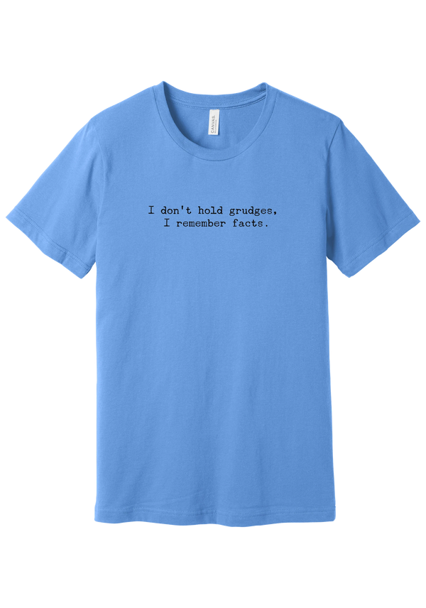 I Don't Hold Grudges tee in Carolina Blue, featuring I don't hold grudges, I remember facts in distressed black typewriter letters