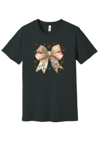 Nativity Bow tee in Dark Grey, featuring a blush satin bow with painted nativity scenes in its ribbons and gold snowflakes