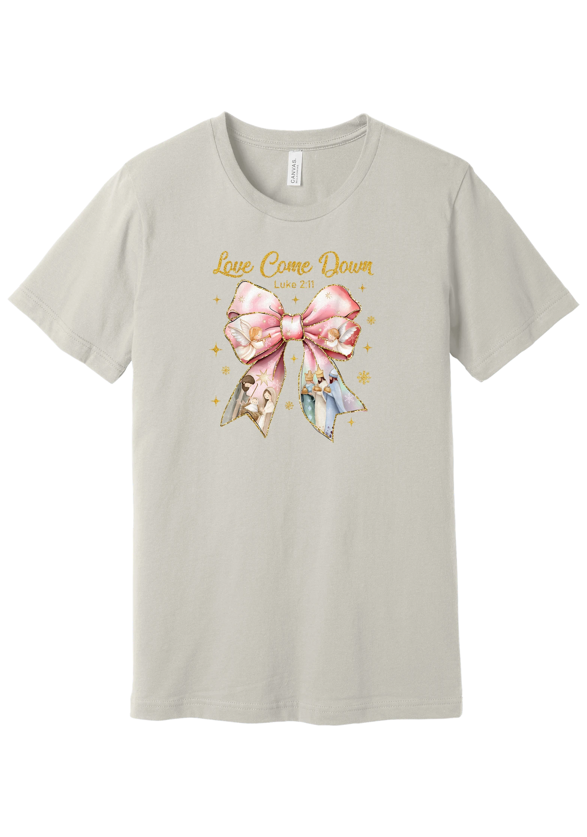 Love Came Down Nativity Bow tee in Dust, featuring a blush satin bow with painted nativity scenes under gold Love Came Down script and Luke 2:11