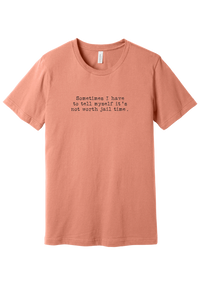 Not Worth Jail Time tee in Sunset, featuring Sometimes I have to tell myself it's not worth jail time in distressed black typewriter letters
