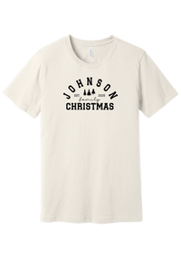 Personalized Family Christmas tee in Vintage White, featuring a personalized family last name arched over three pine trees with EST. and the year
