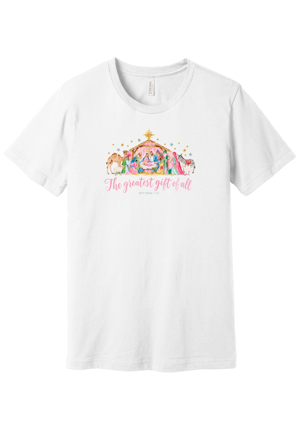 The Greatest Gift of All tee in White, featuring a soft watercolor nativity scene beneath the star with Matthew 1:21