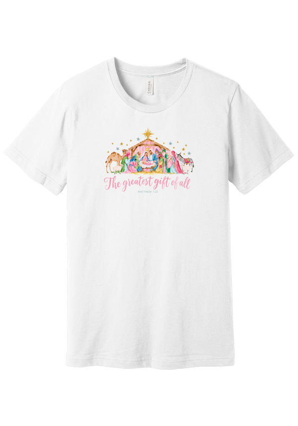 The Greatest Gift of All tee in White, featuring a soft watercolor nativity scene beneath the star with Matthew 1:21