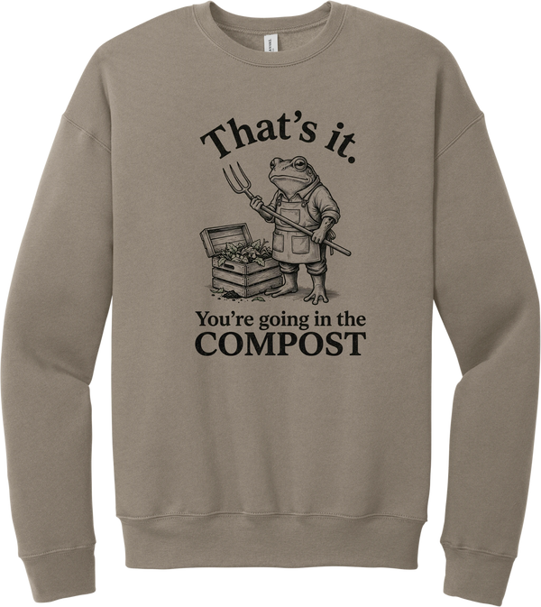 You're Going in the Compost crewneck sweatshirt in Tan, featuring a grumpy frog gardener in overalls holding a pitchfork beside a compost bin with That's it. You're going in the COMPOST