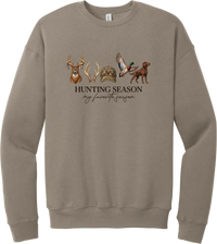 Hunting Season crewneck sweatshirt in Tan, featuring a whitetail buck, antlers, a camo cap, a flying mallard, and a chocolate lab above Hunting Season My Favorite Season lettering