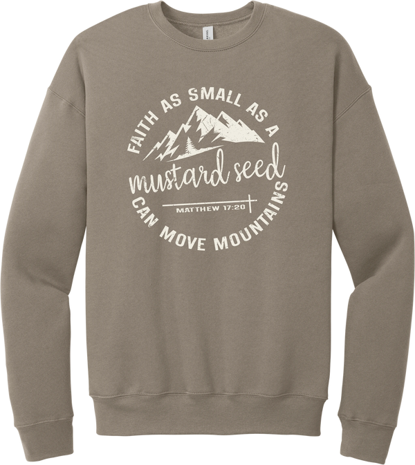 Mustard Seed Faith crewneck sweatshirt in Tan, featuring a circle badge of mountains and a cross with Faith as Small as a Mustard Seed Can Move Mountains lettering and Matthew 17:20